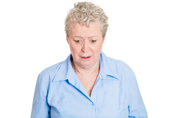 portrait sad lonely senior female looking down white background 