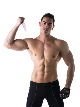Muscular young man holding big knife