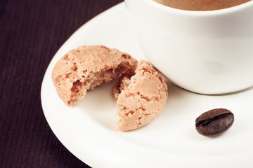 cup of italian espresso coffee and biscuit near coffee bean