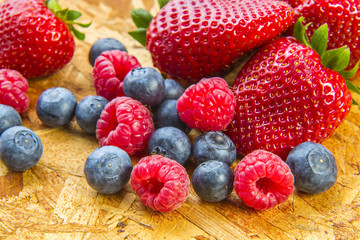 ripe berries on wooden tray