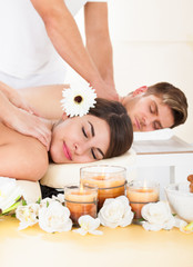Fototapeta na wymiar Couple Receiving Massage At Spa