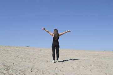 Woman working out on sand (beach, desert, freedom)