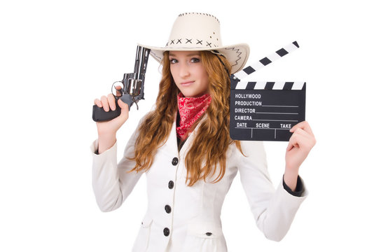Young   cowgirl with gun  and movie board  isolated on white
