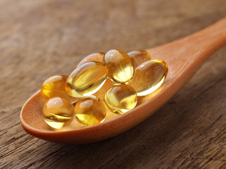 Fish oil capsules in a spoon