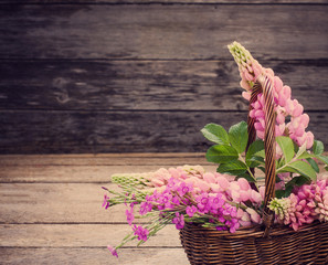 flowers in basket on old background