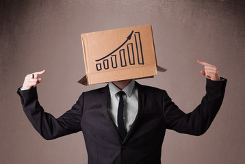 Businessman gesturing with a cardboard box on his head with diag