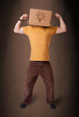 Young man gesturing with a cardboard box on his head with light