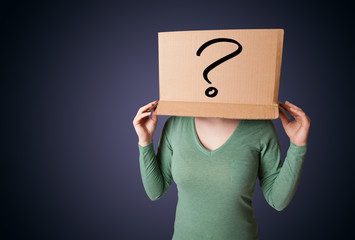 Young lady gesturing with a cardboard box on her head with quest