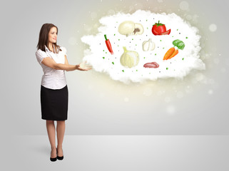 Pretty woman presenting a cloud of healthy nutritional vegetable