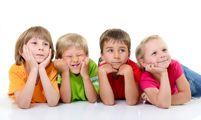 cute funny children in colored t-shirts lying and with interest