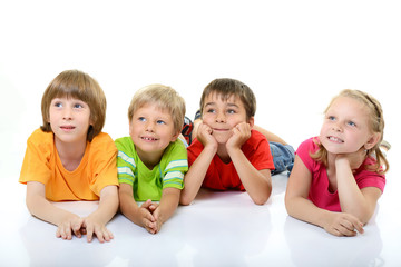 cute children in colored t-shirts lying and smiling looking with