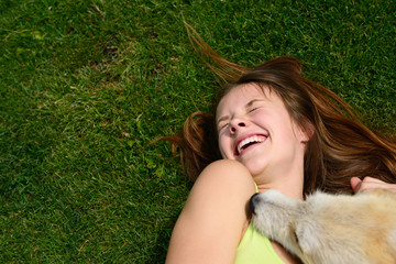 beautiful young happy laugh girl playing with her dog outdoor