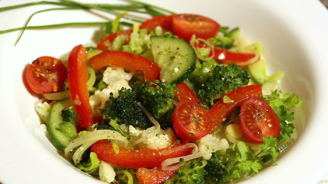 Fresh vegetable salad spinning around