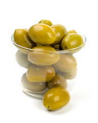 green olives in a glass bowl over white