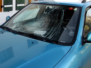 The crashed car heated rear window broken by an accidentally cas