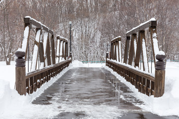 Wooden bridge with snowy surface