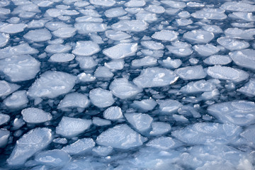Winter nature background with blocks of ice on frozen blue Sea © TuTheLens