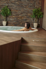 Young woman relaxing in the hot tub