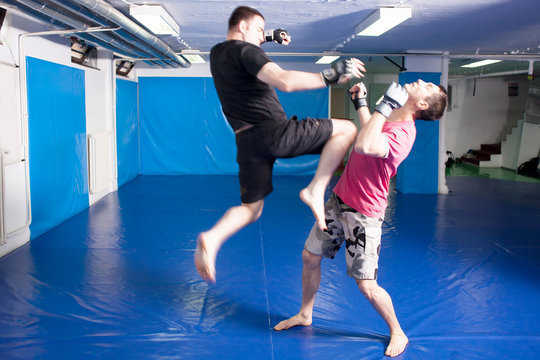 knee kick during mixed martial art training
