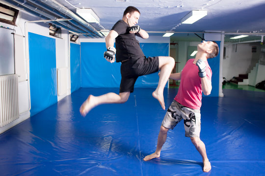 knee kick during mixed martial art training