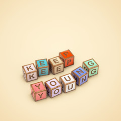"KEEP YOUNG" made of color cubes with letters