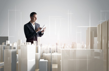 Businessman with tablet PC working with a modern city project