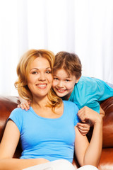 Portrait of smiling mother and son at home