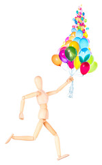 wooden Dummy holding flying balloons isolated