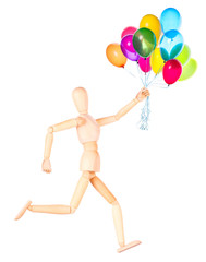 wooden Dummy holding flying balloons isolated
