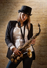 Naklejka premium young beautiful woman with saxophone