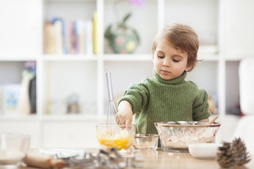 LIttle boy making cookies in the kitchen