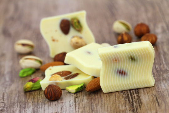 White chocolate pieces with almonds, pistachios and hazelnuts