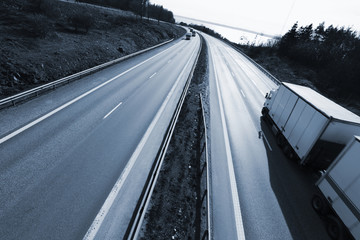blurred truck driving on freeway, elevated view