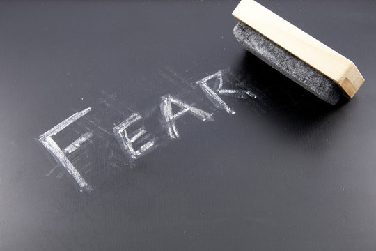 The Word FEAR Being Erased From A Chalkboard