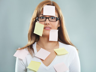 Beautiful young woman covered with post it notes