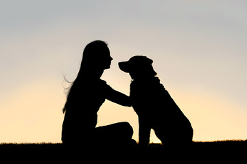 Woman Sitting Outside Petting German Shepherd Dog Silhouette
