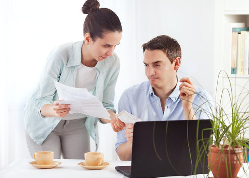 Portrait of a young couple paying bills online