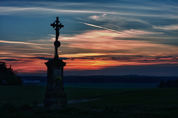 Old cross in sunset