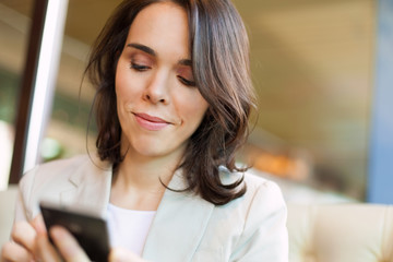 Closeup of a mid adult woman using smart phone.