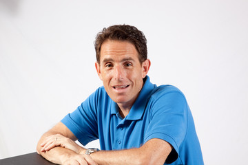 man in blue shirt, smiling at the camera