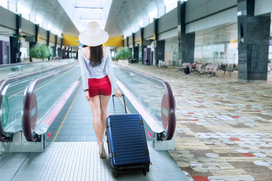 Young woman with a suitcase on the airport
