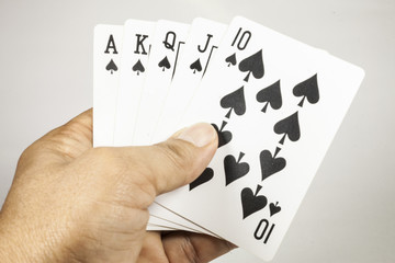 royal flush playing cards in hand