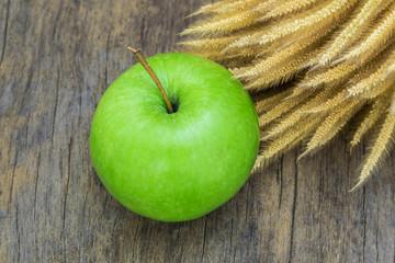 Green Apple on wood background