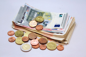 A pile of euro banknotes and coins