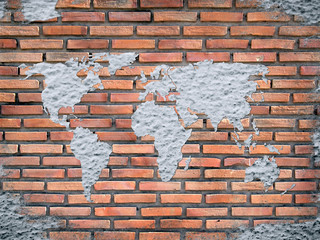 Grunge concrete world map on old brick wall