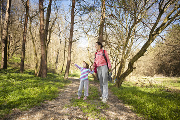 Mother with her little children walking in nature