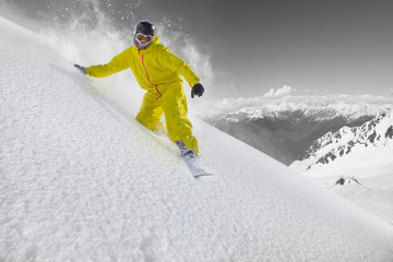 Snowboard rider moving down in snow powder