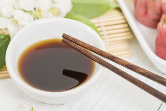 Dumpling Sauce - Chopsticks resting on a bowl of asian sauce
