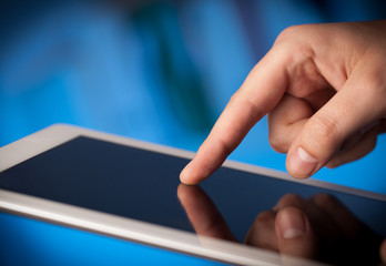 Finger pointing on tablet pc with empty space