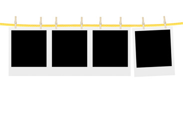 Old photo cards hung with wooden hangers over white